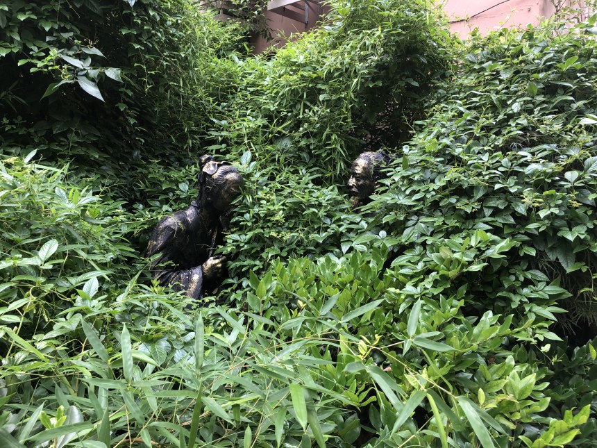 figurines in bushes